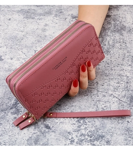 Detail of dusty rose embossed double zipper wallet with hand strap and gold hardware
