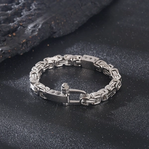Silver stainless steel Byzantine chain bracelet with horseshoe screw clasp on black background