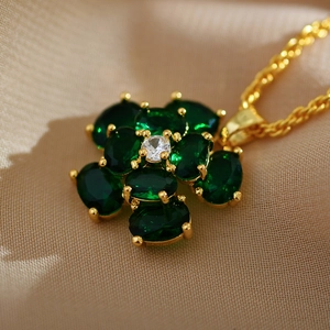 Macro shot of gold-plated flower pendant featuring malachite and crystal setting