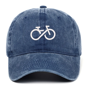 Close-up of bicycle embroidery on blue washed denim baseball cap with curved brim
