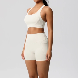 Detail view of off-white yoga set showing high-waist shorts with side pocket and sports bra