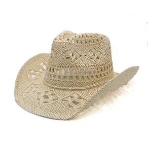 Close-up of beige woven straw cowboy hat featuring intricate diamond cut-out patterns
