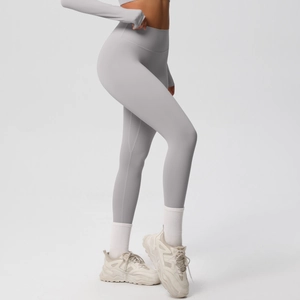 Side view detail of high-waisted seamless light grey leggings showing a slim fit silhouette