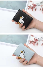 Close-up of black and light blue small vegan leather wallets with cute duck prints
