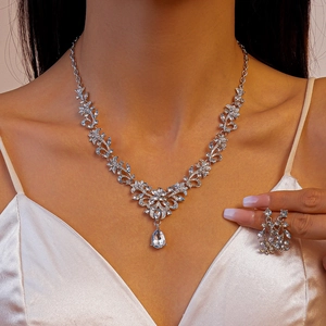 Detail of silver leaf and flower necklace set with a pear-shaped zircon pendant