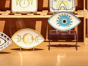 Detailed view of evil eye and moon phase ceramic jewelry trays with gold rim finish