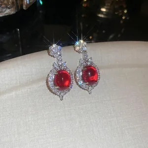 Exquisite vintage oval red crystal stud earrings with pavé diamonds in silver setting