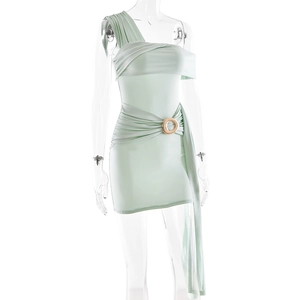 Dettaglio dell'abito monospalla verde menta con anello dorato e texture a pieghe
