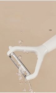 Detail showing the waterproof stainless steel blade being rinsed under water flow