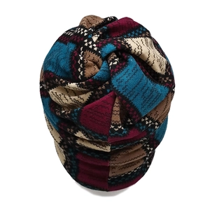 Close-up of thick knit neck warmer with blue and burgundy geometric wavy patterns