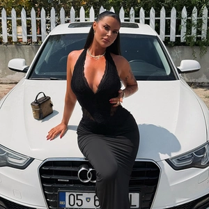 French-style lace halter V-neck dress in black, shown in an outdoor lifestyle setting
