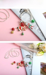 Detailed close-up of Christmas necklace featuring Santa Claus, candy cane, and colorful bells
