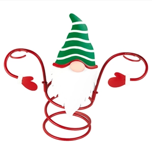 Detail of Christmas wine bottle holder featuring a gnome with green striped hat and red base