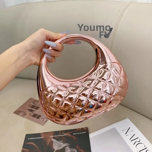Detail of rose gold quilted mirror acrylic clutch with luxury geometric pattern texture