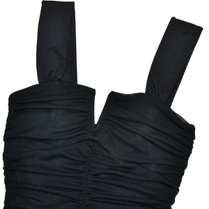Detail of black pleated fabric and wide straps on a slim fit bodycon party dress