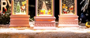 Detail of vintage Christmas snow globe lantern with Santa Claus and festive tree scenes