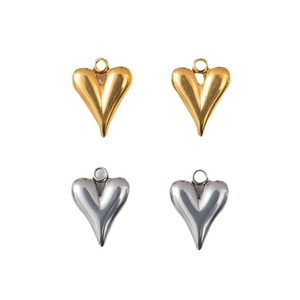 Polished stainless steel heart pendants in gold and silver finish on white background