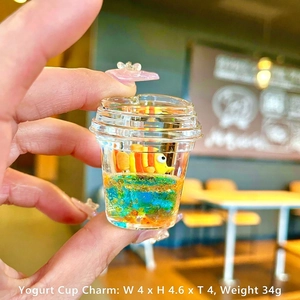 Miniature yogurt cup desk decor featuring an orange clownfish and sparkling blue liquid