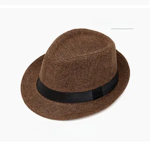 Detailed macro view of coffee color breathable straw fedora hat with black band decoration