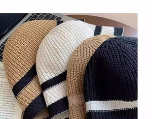 Close-up of striped knitted bucket hats in brown and beige colors with a soft texture