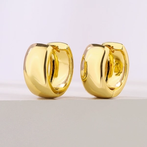 Polished chunky gold hoop earrings with minimalist design and shiny metallic finish
