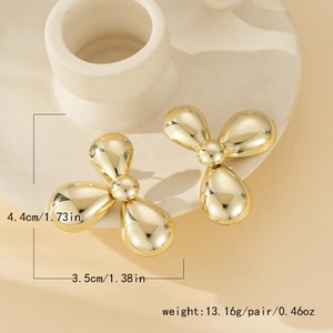 Detailed size view of shiny gold triple-petal metallic earrings with 4.4cm dimensions