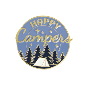 Macro shot of circular enamel camping pin with HAPPY Campers text and forest design