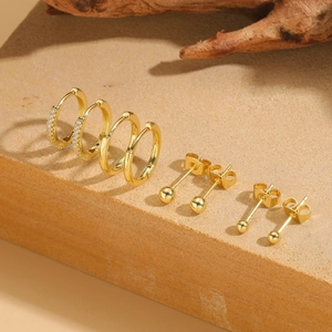 8-piece 14K gold plated earring set with zircon hoops and polished ball studs on stone
