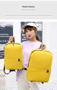Detail view of two different sizes of lightweight yellow backpacks for students and travel