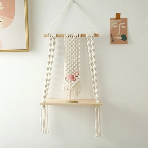 Detail of hand-woven cotton rope and wooden shelf in Nordic Bohemian style for wall decor