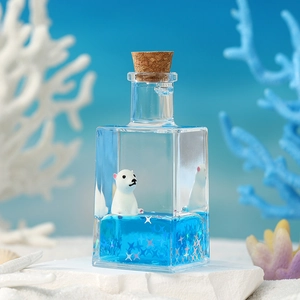 Macro shot of miniature polar bear drifting in a liquid filled glass bottle on stone