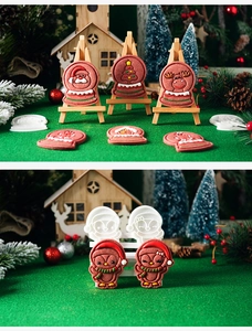 Detailed view of Christmas cookie cutters with penguin and snow globe shaped pastries