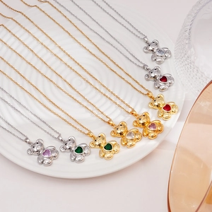 Gold and silver heart bear necklaces with multi-color zircons on white plate