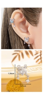 Detail view of silver bow earrings with round crystals and dimensions of 1.56cm x 1.01cm