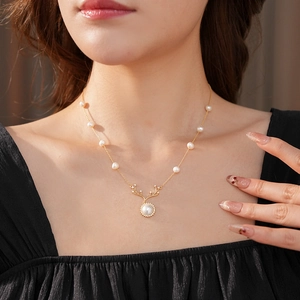 Dettaglio di una collana vintage a corna di cervo con perle e accenti di zirconi lucidi