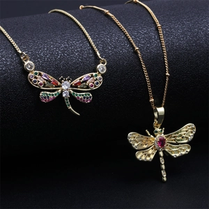 Golden dragonfly necklace with colorful crystals and blue evil eye accent jewelry