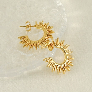 Elegant gold sunburst C-shaped earrings with fan sun flower design on textured glass