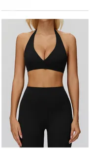 Detail of high-waist yoga leggings and halter sports bra in premium black matte fabric