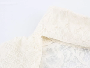 Macro shot of ivory lace short sleeve dress showing detailed mesh texture and stitching