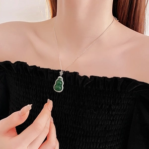 Close-up of green zircon gourd pendant necklace worn on neck in vintage oriental style