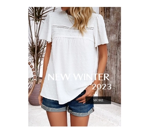 Detail of white short sleeve top featuring lace trim and polka dot jacquard texture
