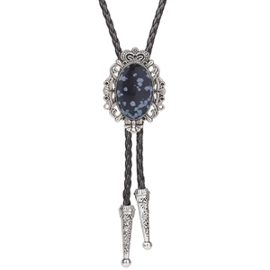 Detail of crown motif bolo tie with snowflake obsidian stone and braided leather cord