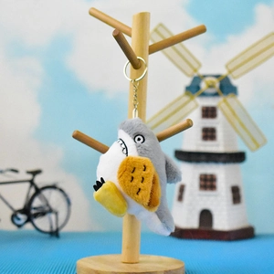 Funny funny plush shark keychain holding toast bread hanging on a rustic wooden stand