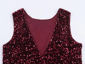 Detailed close-up of burgundy sequin velvet top with deep V-neck and sparkling finish