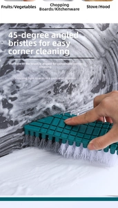 Close-up of flexible cleaning brush scrubbing soapy bathroom tile corners with angled bristles