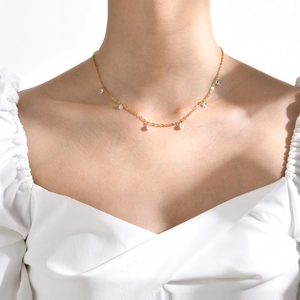 Minimalist 18K gold plated necklace with small sparkling zircon stones on model
