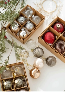 Detail view of assorted 6cm Christmas glass baubles in festive colors and textures