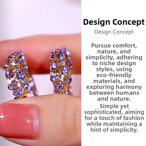 Detailed close-up of golden hoop earrings featuring micro-pave purple zircon gemstones