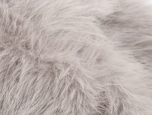 Close-up macro view of high-quality grey faux fur texture on a long winter coat fabric