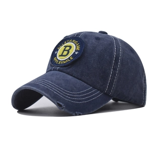 Detail of navy washed cotton baseball cap with embroidered B patch and distressed brim